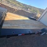 Monsoon Trailer Rental - flatbed utility trailer parked in a residential driveway for equipment hauling.