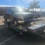 Ford F-150 truck on a Monsoon Trailer Rental LLC flatbed trailer.